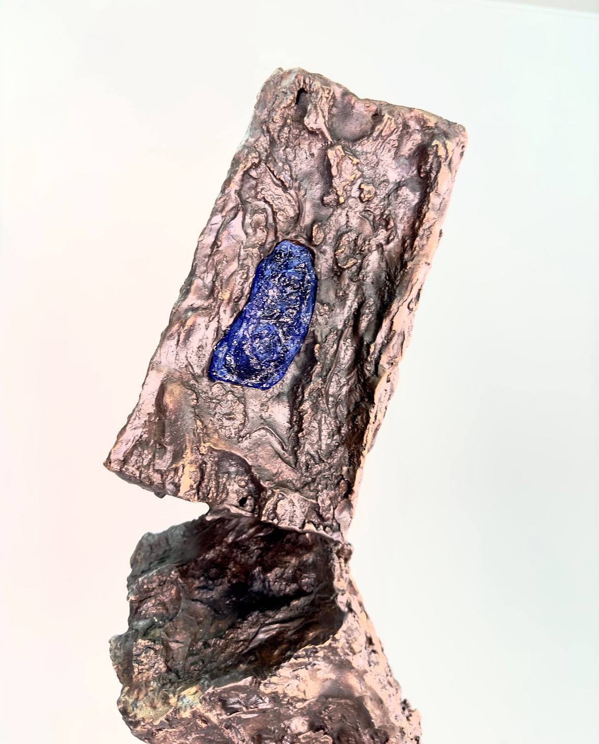 Detail of one cast-bark block of Hangman's Elm, a cobalt glass inclusion set into the coppery bronze.